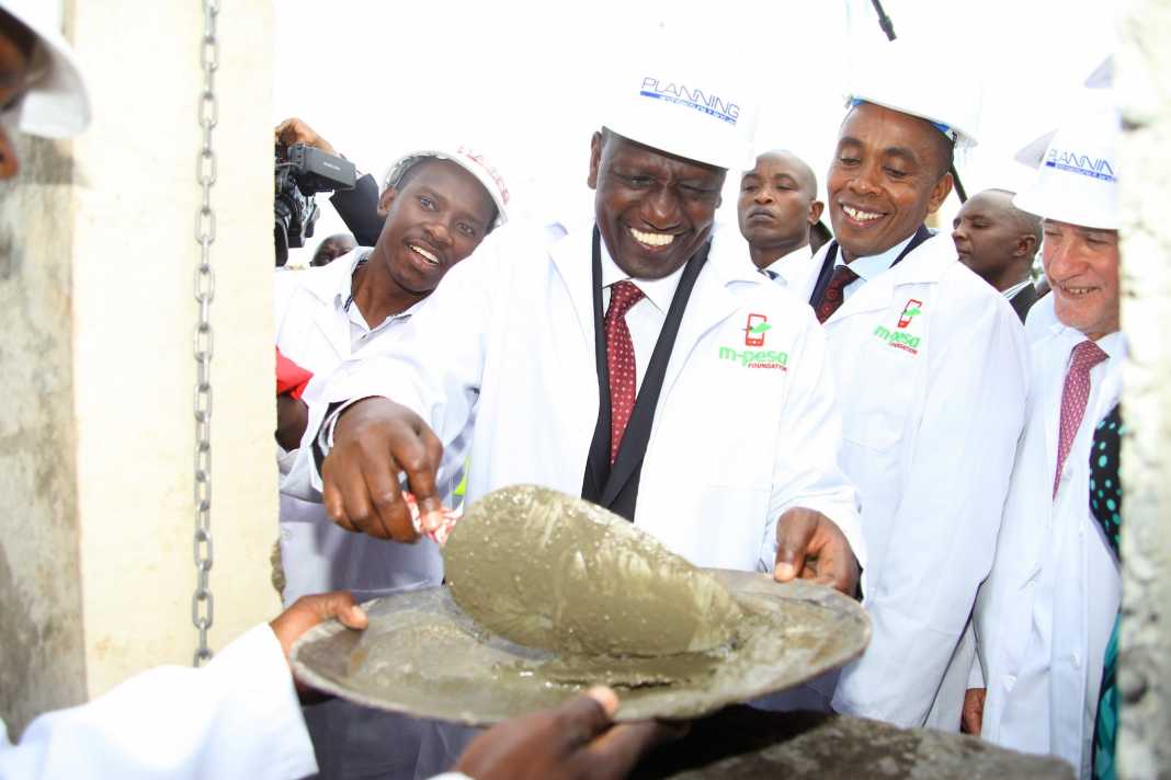 Deputy President William Ruto during the laying of the Foundation stone at the M-Pesa Foundation academy in Mang’u, Thika. Looking on is Michael Joseph at the extreme right.