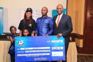 31 year old AMos Waweru from Murang'a with his wife and children as they received their Ksh 10 million cash prize from mCHEZA CEO Peter Karimi.