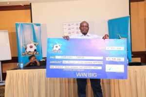 Year old Samson Juma from Kakamega shows his Ksh.10.7 million winnings courtesy of gaming platform mCHEZA.
