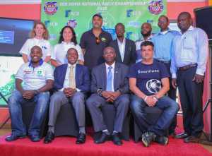 KCB Regional Business Manager - Nairobi, Metric Mukhalasie (second right, seated) poses for a group photo with KMSF Officials and rally drivers - Bizna