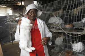 Josephine Razugu with her rabbits. Photo / The Standard.