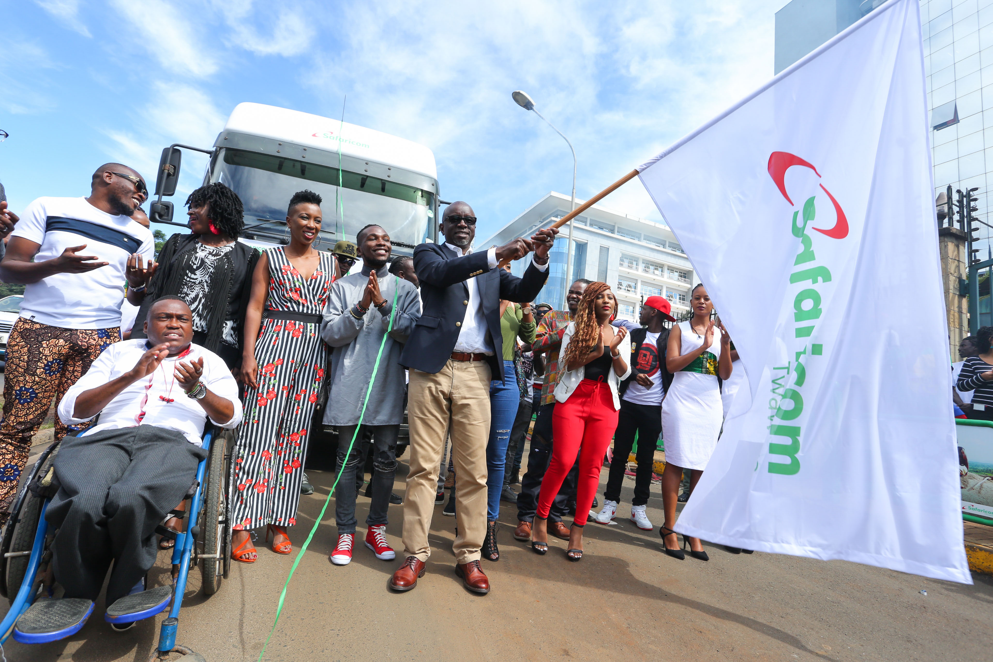 Safaricom, Director Regional Sales Operations, flanked by various artists as he Flags off the Twaweza Live Caravan at Safaricom Headquarters. - Bizna