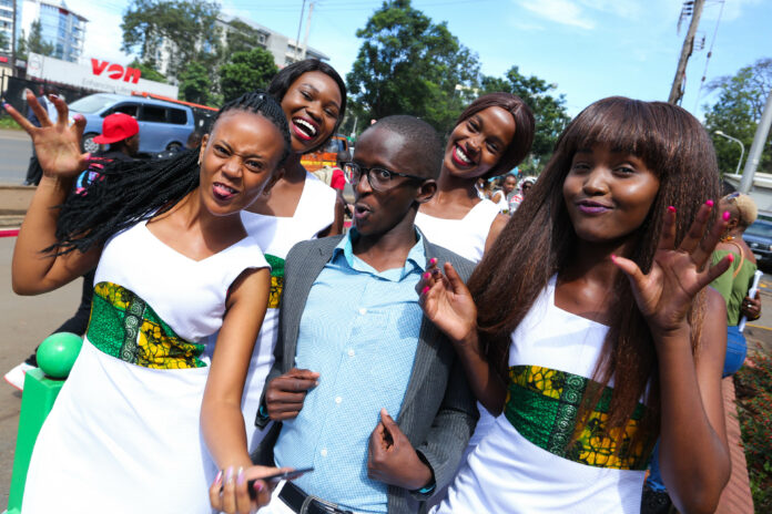 Comedian Njugush poses with models during the Safaricom Twaweza Flag off at Safaricom Headquarters. - Bizna