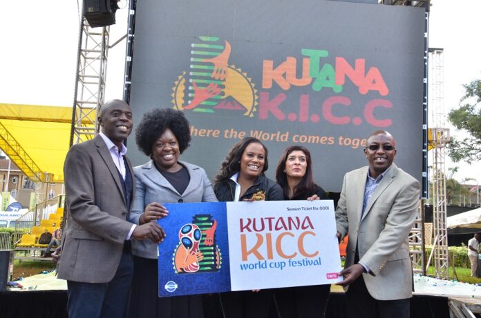 (From Left) Myke Rabar CEO Homeboys Group, Janet Ouko, Nairobi County Executive for Youth Sports and culture, Nana Gecaga, CEO KICC, Jay of Jays Pyrotechnics, and Daniel Koech, Sales and Marketing Director, holding a dummy ticket for the Kutana KICC World Cup Festival that was Launched at the KICC on May 4, 2018. Football fans will have a chance to view the World Cup at the Festival that will be held from June 14, 2018 until July 15, 2018 - Biznakenya.com