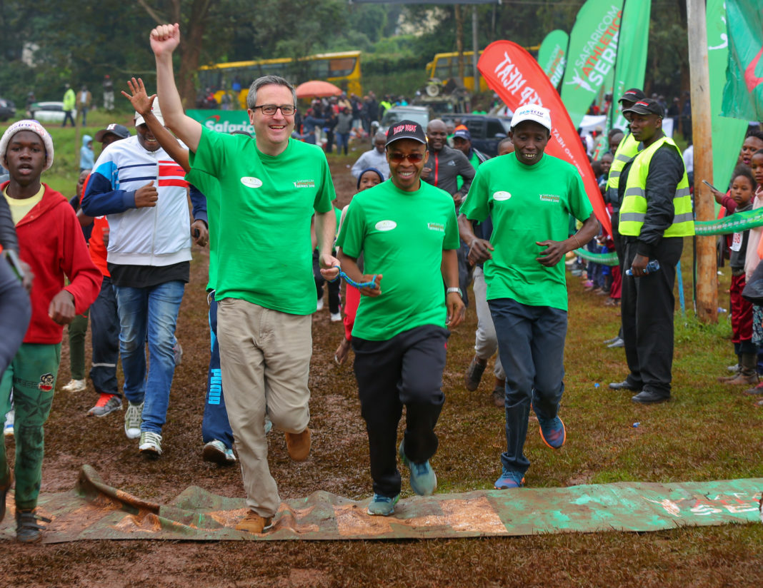 The British ambassador to Kenya Nic Hailey, Henry Wanyoike and Charles Kandie, Henry Wanyoike’s guide cross the finishing line in the 8th edition of the Henry Wanyoike Run for The Future race in Kikuyu town over the weekend.