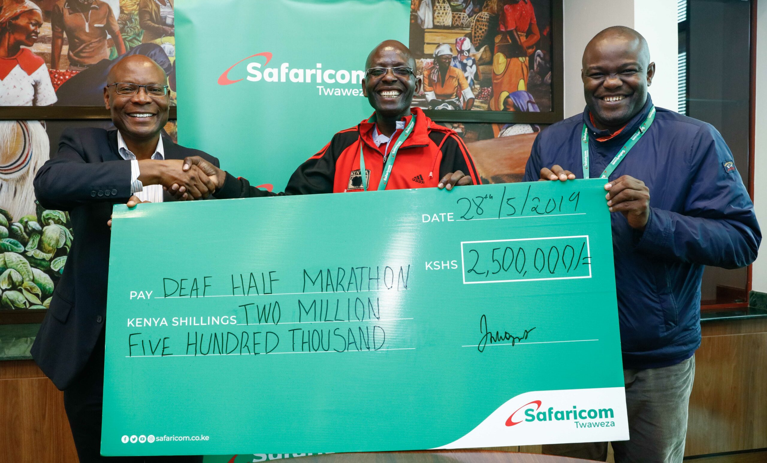 Joseph Ogutu, Safaricom’s Chief Special Projects Officer (left) presents a dummy cheque of KES 2.5Million to Benard Banja Secretary General, Deaf Athletics Association of Kenya (DAAK) and Tom Okiki Public Relations Officer (DAAK) ahead of the upcoming Kericho Deaf Half marathon slated for 16th June. - Bizna Kenya