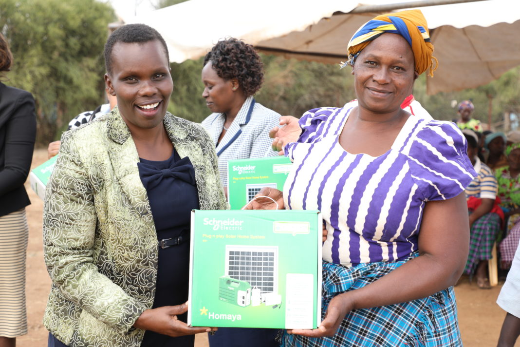 Compassion International team led by Linet Ochieng, Senior Manager Business Support demonstrate to the beneficiaries how to use the Homaya Solar Lighting Solution in one of the homes in Sultan Hamud - Bizna Kenya