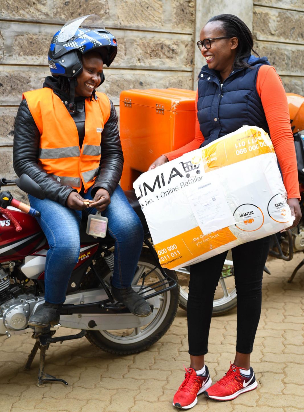 Jumia Kenya Chief Operations Officer, Christine Sogomo, chats with one of the Delivery Agents, Lillian Muyonga, during a delivery session at Adams - Bizna