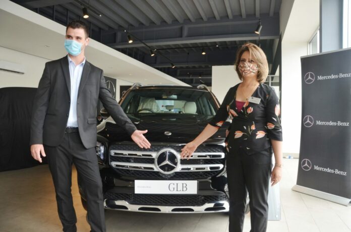Matt Olivier (left), the Director Business Development at DT Dobie and Maliha Sheikh (right), the General Sales Manager, Mercedes Benz cars and vans present the new Mercedes Benz GLB 200 compact SUV at a launch function in the DT Dobie showroom on Uhuru Highway - Bizna