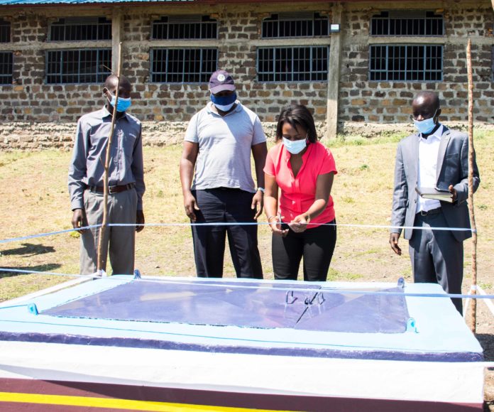 KBL's Head of Sustainability Arnolda Shiundu cuts the ribbon during the official opening of the water project in Magunga, Homabay County. She was accompanied by representatives from the Lake Basin Development Authority, who are the implementing partner, and the area's community leaders. The water project in Magunga is expected to benefit 18,oo0 people who have been facing challenges in accessing clean water - Bizna Kenya