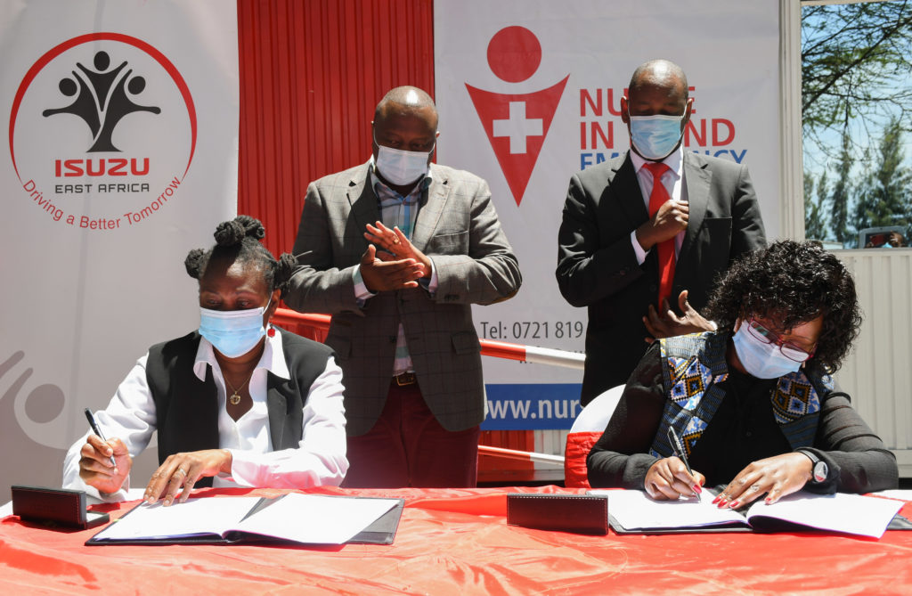 Rita Kavashe, Managing Director, Isuzu East Africa; Lucy Njuguna, Managing Director, Nurse In Hand, (seated) signing a partnership agreement, following the official launch of the first Northern Corridor Highway Emergency Response Center. Looking on is George Ngao, (left standing) Director General, National Transport and Safety Authority (NTSA) and Dr. George Ndichu, (Right) Representative, Naivasha Sub County hospital. The Center, which is the first of its kind in Kenya is designed to provide a base where paramedics can be deployed rapidly to accident spots and save lives before evacuation to the nearest hospital, for road users along the busy Nairobi - Nakuru highway - Bizna Kenya