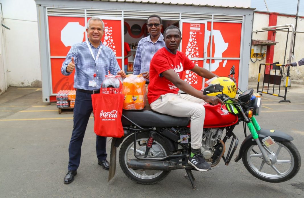 Coca-Cola Beverages Africa, Sales and Marketing Director, Josphat Mwangi (left) with Franchise Director, Kenya and Tanzania, Oliver Soto (centre) and Kevin Abunyolo a deliveries rider pose for a photo during the launch of DialACoke at Nairobi bottlers offices in Embakasi - Bizna Kenya