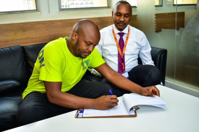Mwananchi founder and CEO Dennis Mombo with Felix Odiwuor aka Jalang’o during the signing of the brand ambassador agreement - Bizna Kenya