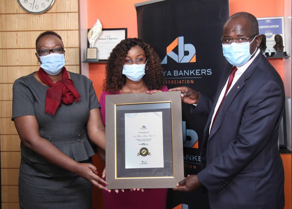 Credit Bank's Contact Centre and Customer Experience Manager, Judith Wanjala (left) and Monica Chege, Senior Manager, Marketing and Communications at Credit Bank (centre), receive the 1st Place - Best in Tier 3 Award from Dr Habil Olaka, Chief Executive Officer Kenya Bankers Association, during the unveiling of KBAs Customer Satisfaction Survey 2020. Credit Bank received recognition for Customer Responsiveness and Digital Experience for the third year in a row - Bizna Kenya