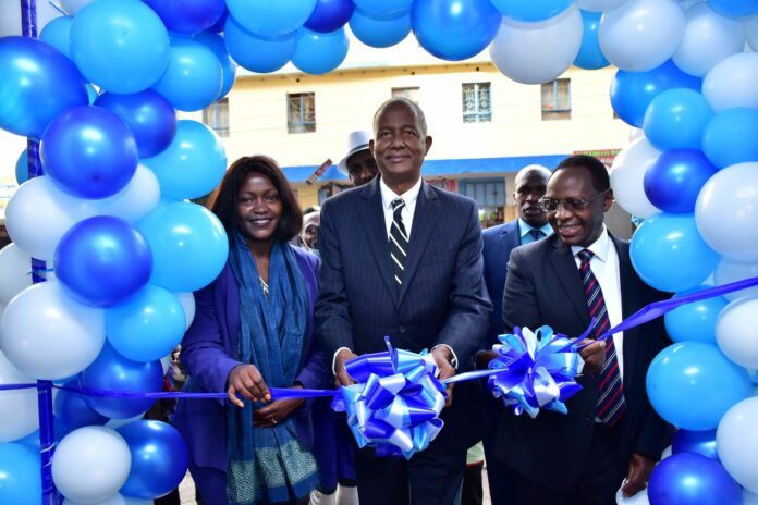 Kamukunji MP Hon. Yusuf Hassan (C) cuts a ribbon to mark the official opening of Family Bank Eastleigh branch. He is with the bank's CEO Rebecca Mbithi (L) & Chairman Dr. Wilfred Kiboro - Bizna Kenya