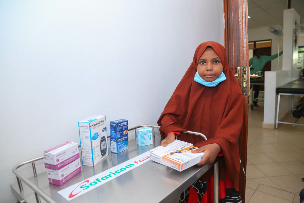 Sambrim Said, with her diabetes kit and medicine donated by Safaricom Foundation - Bizna Kenya