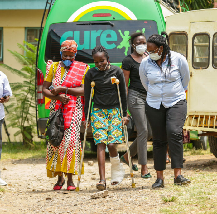 Ida Juma, Safaricom Foundation Senior Programmes Officer (left), Safaricom PLC with Beverly Auma (centre), a beneficiary of the Wezesha Elimu Programme at Homabay Level 5 Hospital - Bizna Kenya