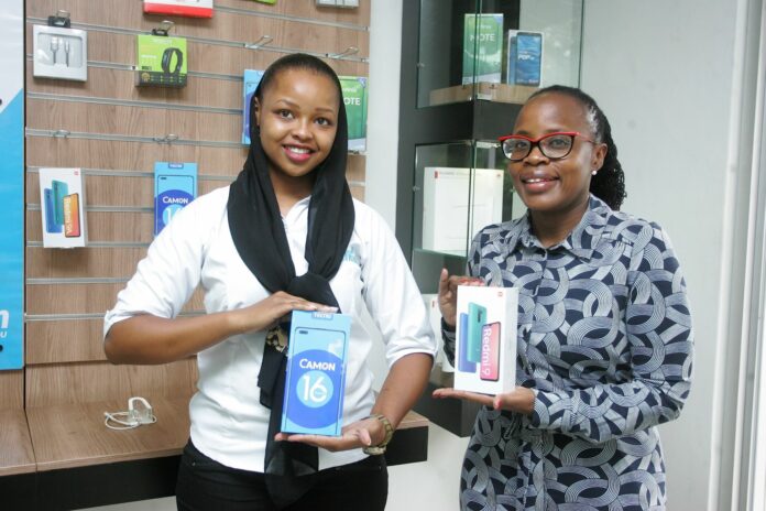 Telkom Sales Agent, Yasmin Njeri and Telkom Director Customer Experience test the new smartphones under the Valentines promotion at Telkom shop at Ralph Bunche Rd.Telkom Kenya has partnered with phone vendors to offer mobile phones at accessible price points as the perfect Valentine’s Day gift for the rural and urban youth customer - Bizna Kenya