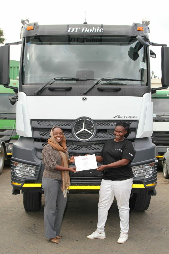 Certificate award - Halima Said Ahmed (left), DT Dobie Customer Relationship Manager awards a Certificate to Emma Nduta (right), a truck driver after she completed a three day advanced Mercedes Benz training programme organized by the Company for women truck drivers to mark International Women’s Day - Bizna Kenya