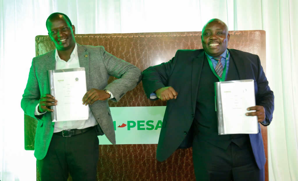 Safaricom Chief Financial Services Officer, Sitoyo Lopokoiyit (left) and HELB Chief Executive Officer, Charles Ringera (right) signing a partnership on mobile disbursements under HELB through M-Pesa during its official launch at the CEO’S lounge - Bizna Kenya