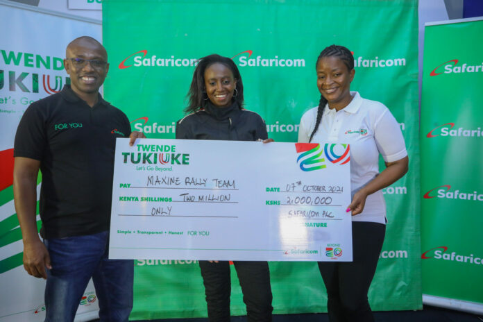 Rally Driver Maxine Wahome (R) and her co-driver Linet Ayuko (L) hold a dummy cheque during Safaricom Cheque Handover at Safaricom Headquarters - Bizna Kenya