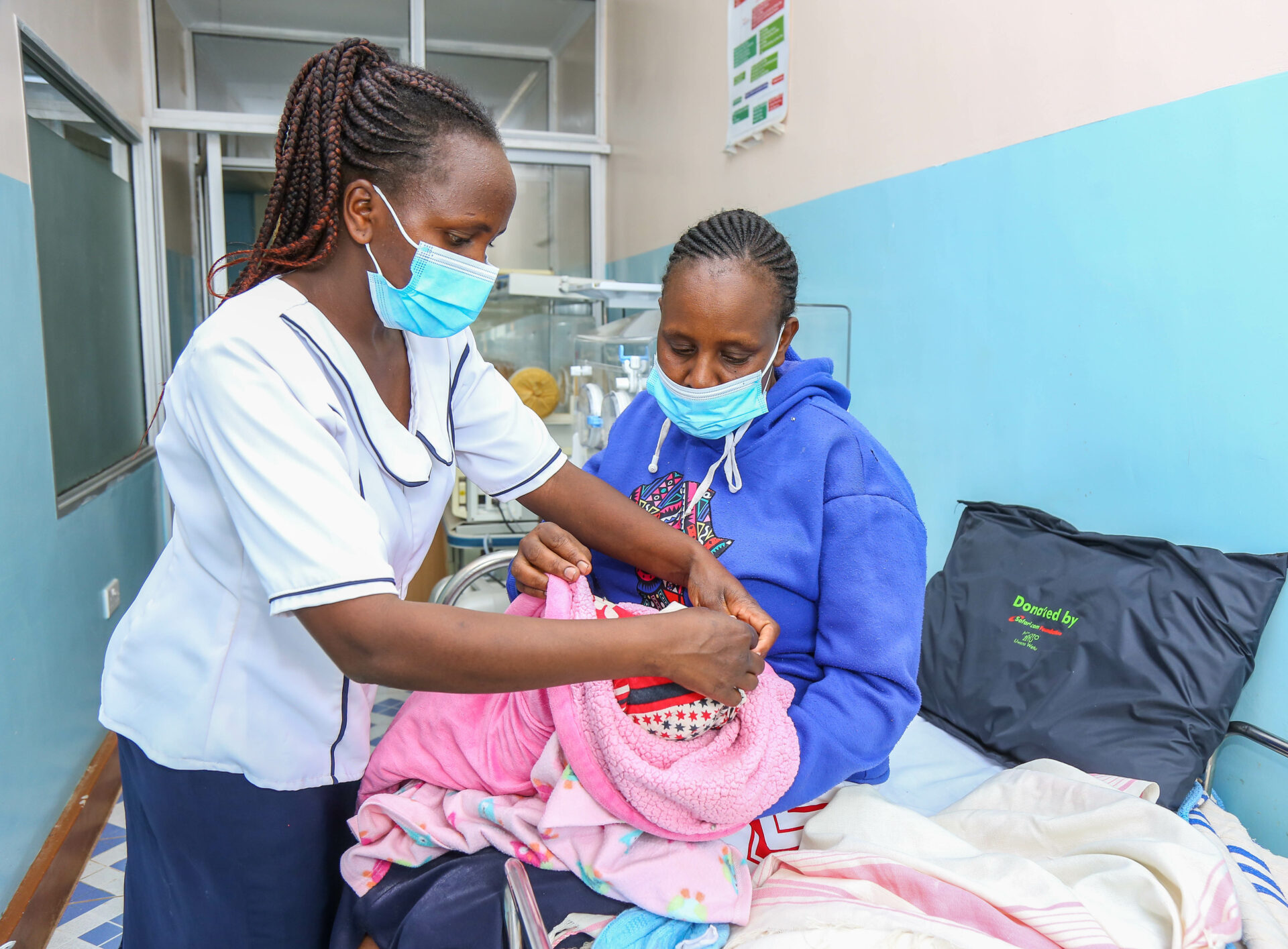 Nurse in charge, Bissil Health centre, Magdalene Sarite (L) examines Beatrice Rimanto’s newborn (R) during the official handover of a newborn incubator, hospital beds, suction machine and Oxygen Concentrator donated by Safaricom Foundation’s Ndoto Zetu initiative which is in its third phase. Over one million Kenyans are expected to benefit from Safaricom Foundation’s Ndoto Zetu Initiative - Bizna Kenya