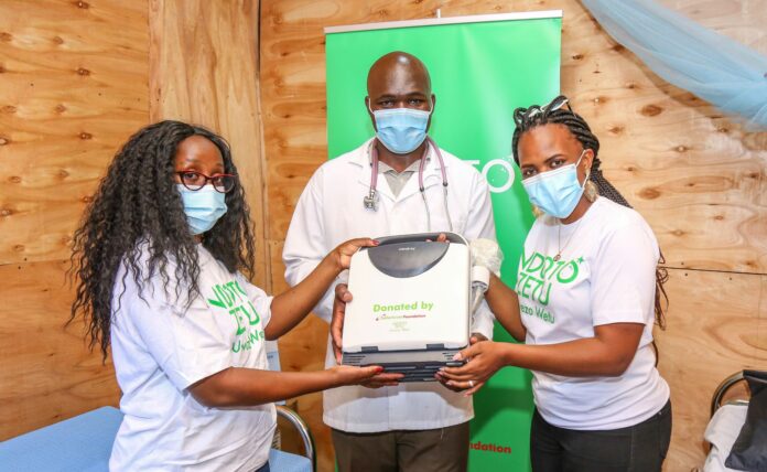 Dr Chris Owayo of St Mathews Mission Hospital, Mukuru Kwa Reuben (C) receives an Ultrasound Machine from Safaricom PLC’s Faith Mbinya and Safaricom PLC’s Jane Mutheu donated by Safaricom Foundation’s Ndoto Zetu initiative which is in its third phase. Over one million Kenyans are expected to benefit from Safaricom Foundation’s Ndoto Zetu Initiative - Bizna Kenya