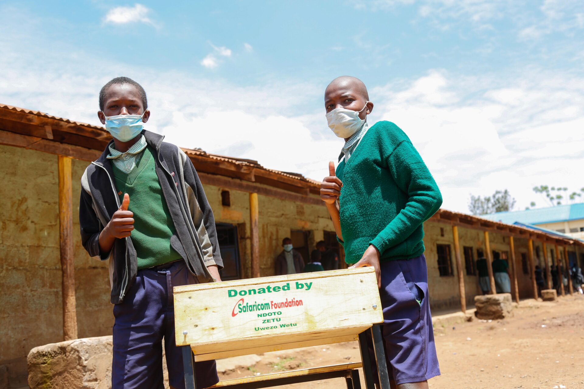 John Maina (L) and Collins Mwangi (R), pupils from Gachororo Primary School, Kiambu County during the official handover of co-joined desks and chairs donated by Safaricom Foundation’s Ndoto Zetu initiative which is in its third phase. Over one million Kenyans are expected to benefit from Safaricom Foundation’s Ndoto Zetu Initiative - Bizna Kenya