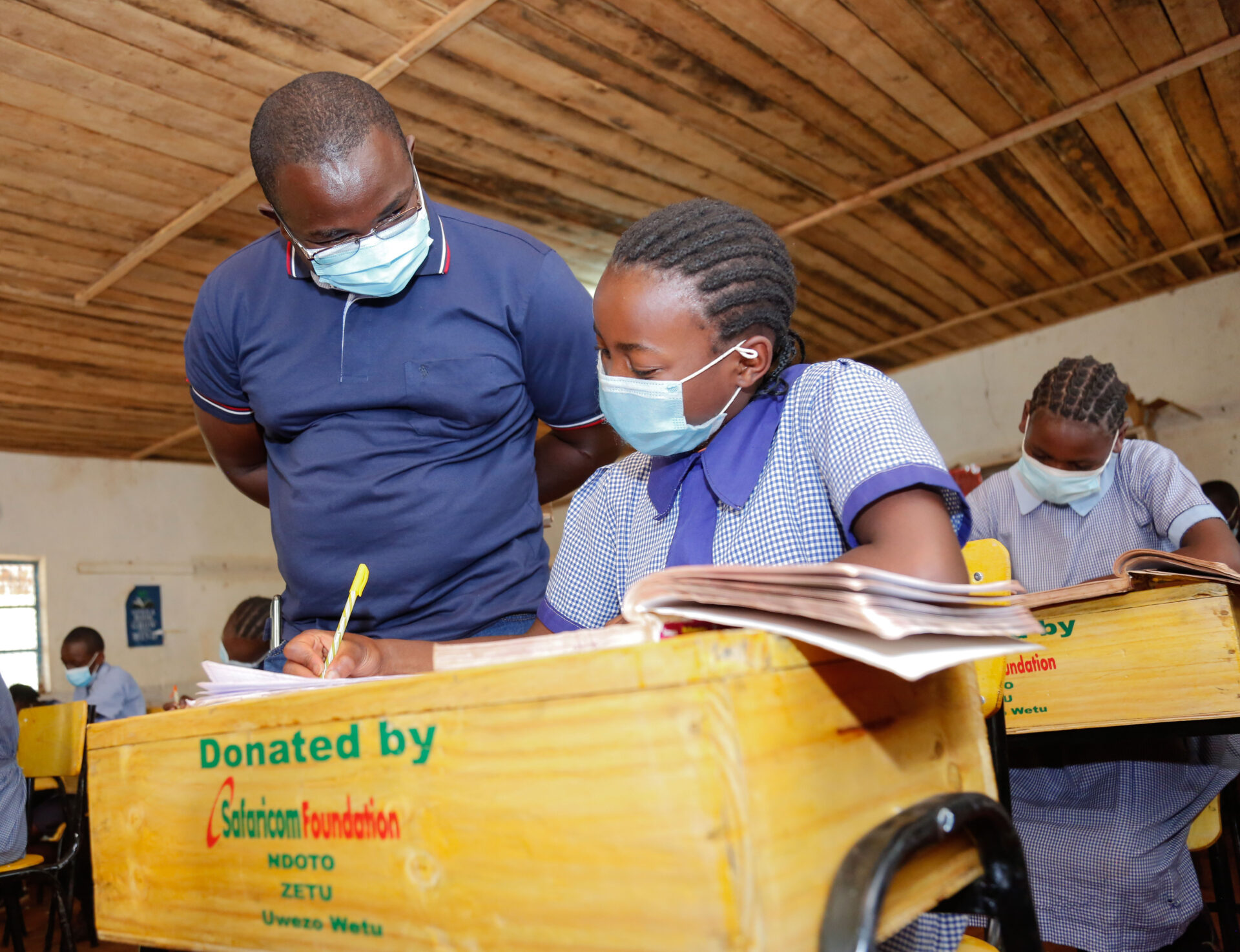 Safaricom PLC Retail Account Manager, Benjamin Njoroge (L) interacts with Jane Wambui, a pupil from Kiamwangi Primary School, Kiambu County (R), during the official handover of lockers and chairs donated by Safaricom Foundation’s Ndoto Zetu initiative which is in its third phase. Over one million Kenyans are expected to benefit from Safaricom Foundation’s Ndoto Zetu Initiative - Bizna Kenya