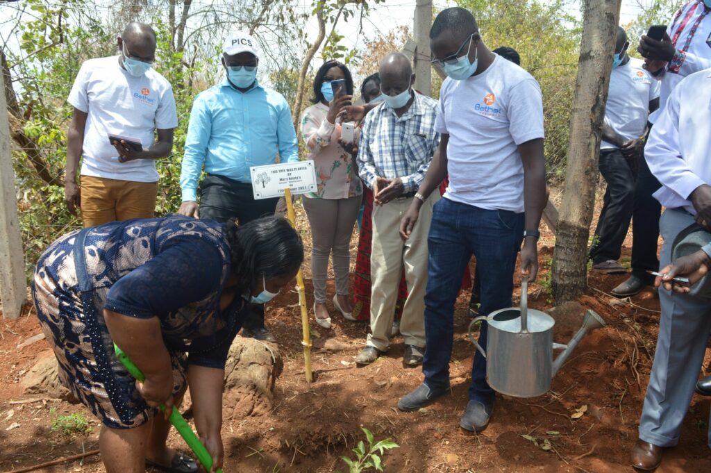 Bethel Network Director, Mary Ndungu planting a a tree during the inauguration Ceremony of The Maragua Ridge Water and Food Security Program - Bizna Kenya