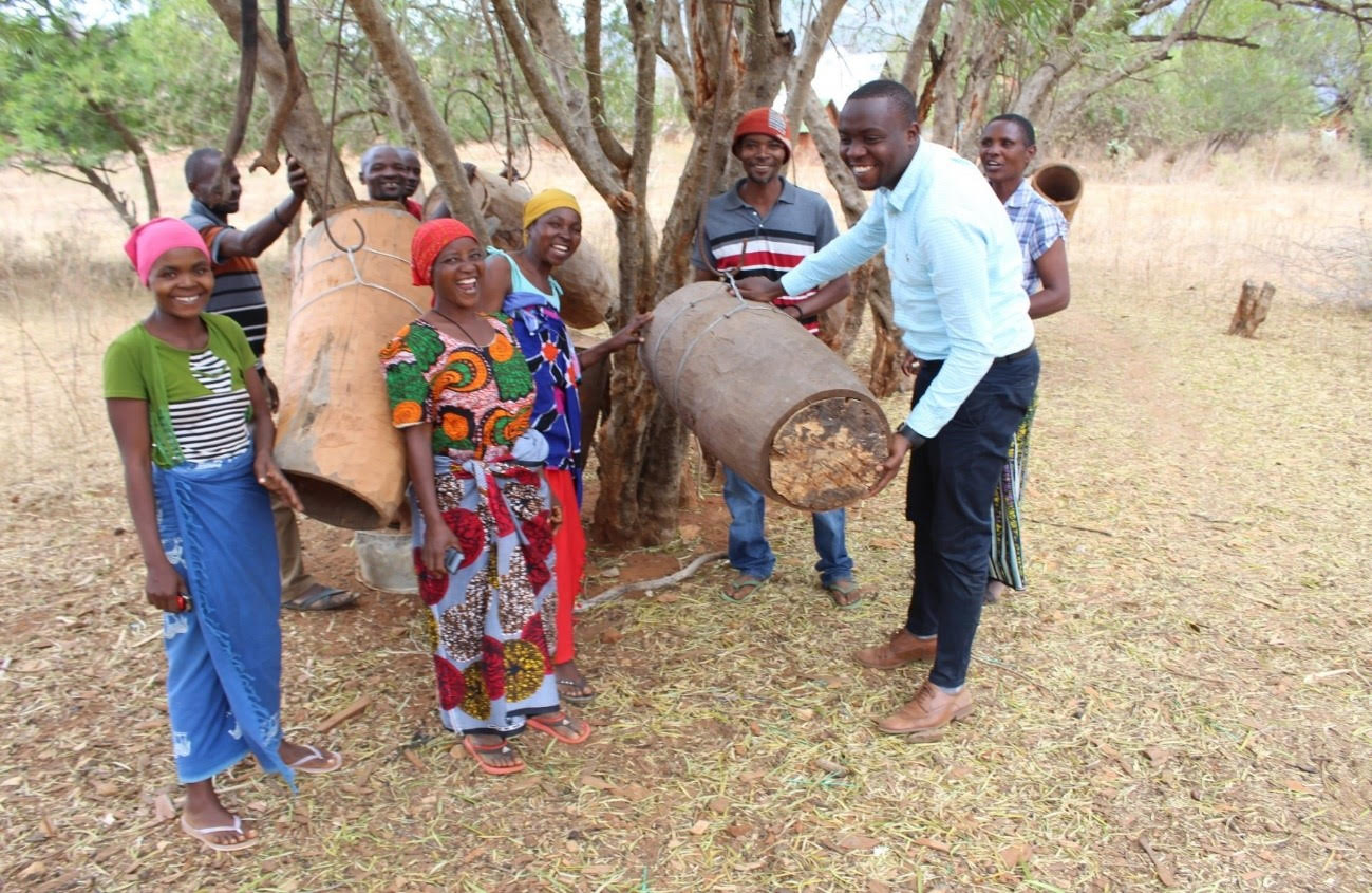 Hand in Hand and Boeing’s project entrepreneurs, Mkomazi group with their Business Trainer and beehives used for honey production, Kilimanjaro Region, Tanzania - Bizna Kenya