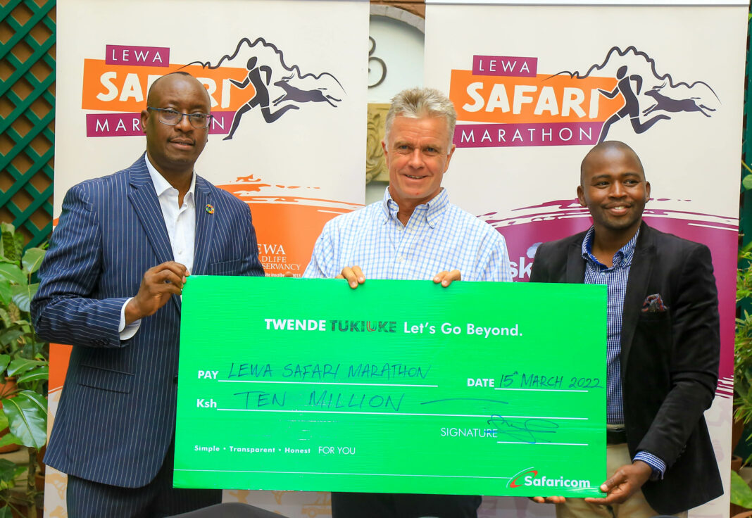Chief Human Resources Officer Safaricom PLC Paul Kasimu (L) pose with a dummy cheque for Kshs. 10 Million to support the Lewa Safari Marathon as Mike Watson(C),CEO Lewa Wildlife Conservative and John Kinoti(R) Community Development Manager Lewa Marathon. This was during the Official Launch of the Lewa Safari Marathon 2022 and cheque handover at Sarova Stanley Nairobi today - Bizna Kenya