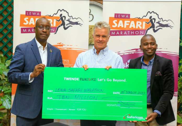 Chief Human Resources Officer Safaricom PLC Paul Kasimu (L) pose with a dummy cheque for Kshs. 10 Million to support the Lewa Safari Marathon as Mike Watson(C),CEO Lewa Wildlife Conservative and John Kinoti(R) Community Development Manager Lewa Marathon. This was during the Official Launch of the Lewa Safari Marathon 2022 and cheque handover at Sarova Stanley Nairobi today - Bizna Kenya