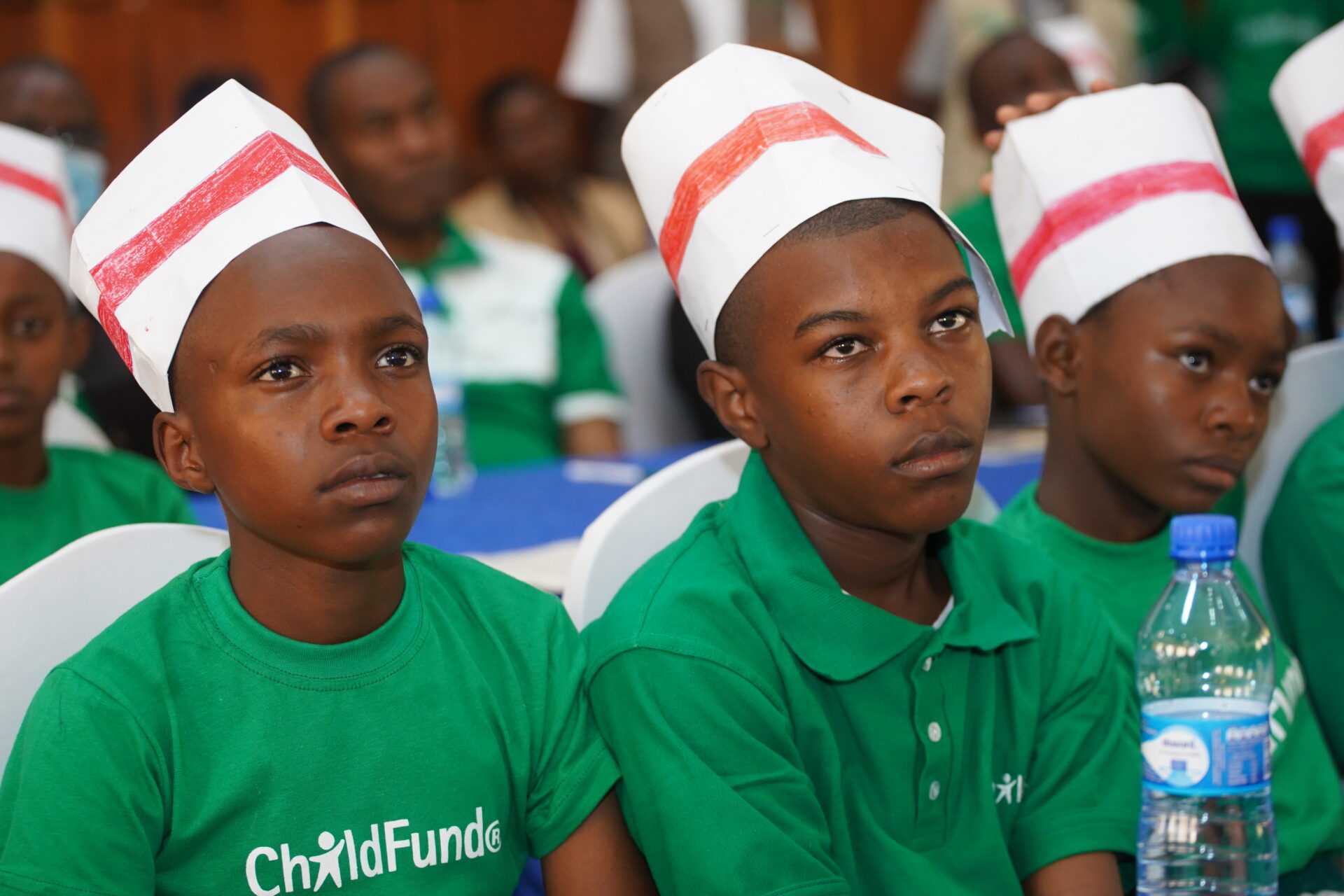 Children, who are the main beneficiaries of ChildFund Kenya programmes, listen to speeches during the launch of the five-year strategic plan - Bizna Kenya