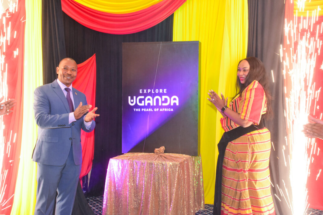 His Excellency Aryabaha P. Evans, Deputy High Commissioner of Uganda to Kenya (left), Uganda Tourism Board Marketing Manager Claire Mugabi unveil the new Uganda Tourism Brand during a Kenyan roadshow aimed at boosting cross-border tourism between the two East African Countries - Bizna Kenya