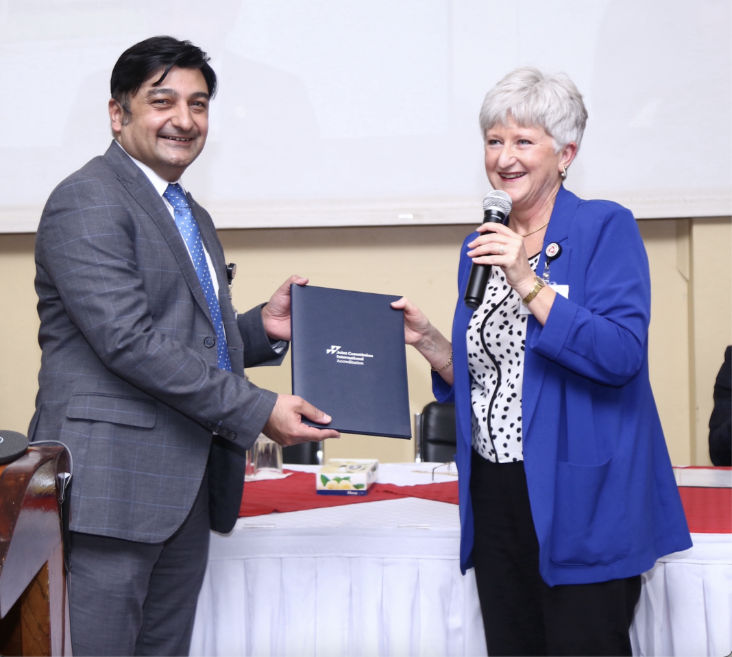 Mr. Rashid Khalani, CEO, Aga Khan University Hospital, Nairobi receives a preliminary report of audit findings from Helge Springhorn, RN Surveyor at Joint Commission International (JCI) following the successful completion of the hospital’s 4th accreditation audit process in June 2022 - Bizna Kenya