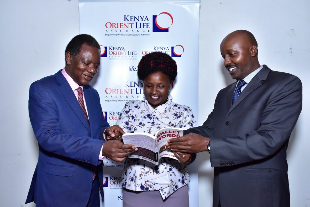 Financial coach Wahome Ngari showcases his book to Kenya Orient Life Assurance GM Jackson Muli(R)& Agency Manager Annflorence Makanga during the handover of the books to the agency managers of the life assurance provider in a bid to upscale their financial skills to better serve customers.