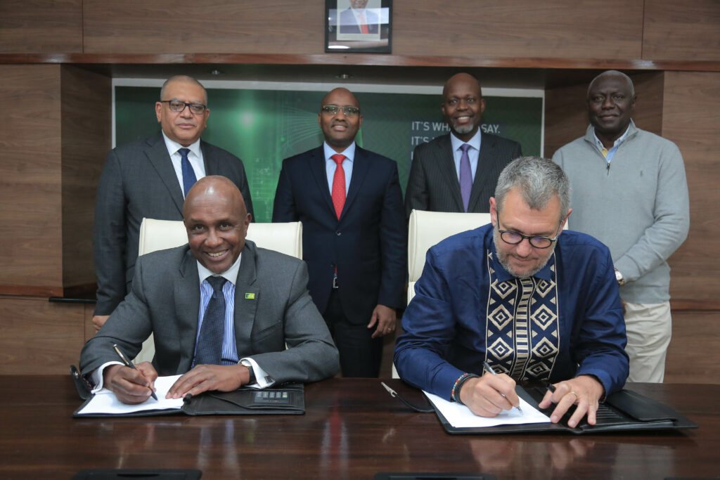 KCB Group PLC Chairman Andrew Wambari Kairu and Oliver Meisenberg, the Chief Executive Officer Trust Merchant Bank (TMB) sign documents earlier today during a ceremony where KCB signed a definitive agreement to acquire a majority stake at TMB. TMB is a commercial bank based in the Democratic Republic of Congo (DRC). They are flanked by from left TMB Deputy CEO, Alexandre Mandeiro, KCB Group CEO Paul Russo, KCB Group CFO, Lawrence Kimathi and TMB Shareholder Christian Kabila.  The acquisition is aligned to the Group’s bid to scale its regional presence and access to the new Member of the East African Community - Bizna Kenya