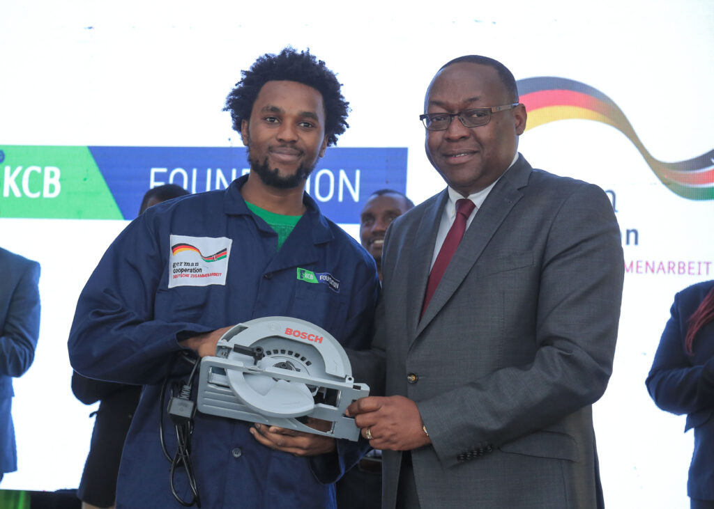 Nairobi City County Deputy Governor, James Njoroge Muchiri (right) handing over toolkits to Jude Muturi (left), one of 75 beneficiaries who received trade-specific building and construction toolkits from KCB Foundation and GIZ. In the last one year, KCB Foundation and GIZ have issued over 400 construction toolkits worth KES 19 million to youth across 11 Counties in the Country - Bizna Kenya