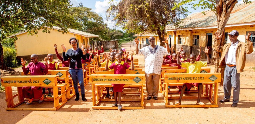 Kyaume Primary School students and teachers celebrating delivery of new desks by Kakuzi Plc - Bizna Kenya (Publisher)
