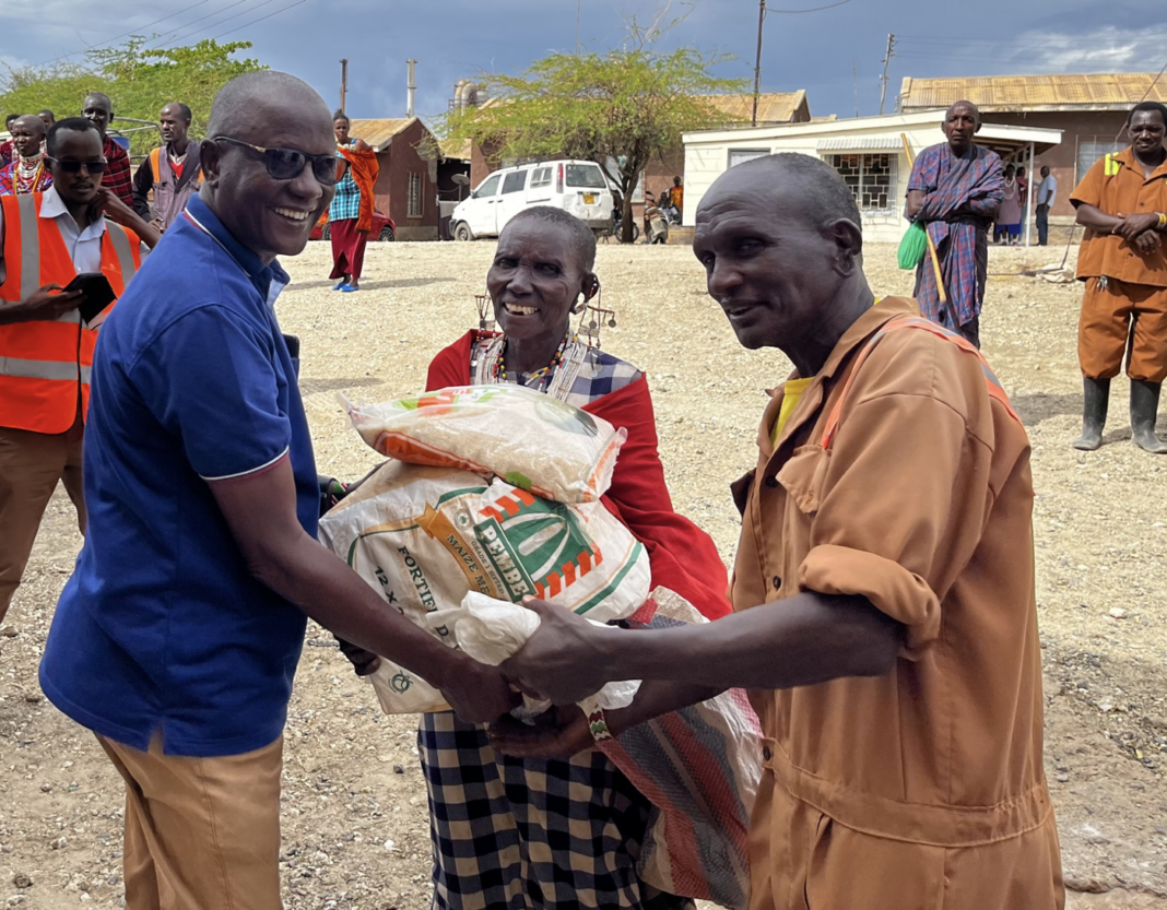 Picture Caption: Senior Chief Joel Saiyanka helps with the distribution of food to the community. - Bizna Kenya (Publisher)