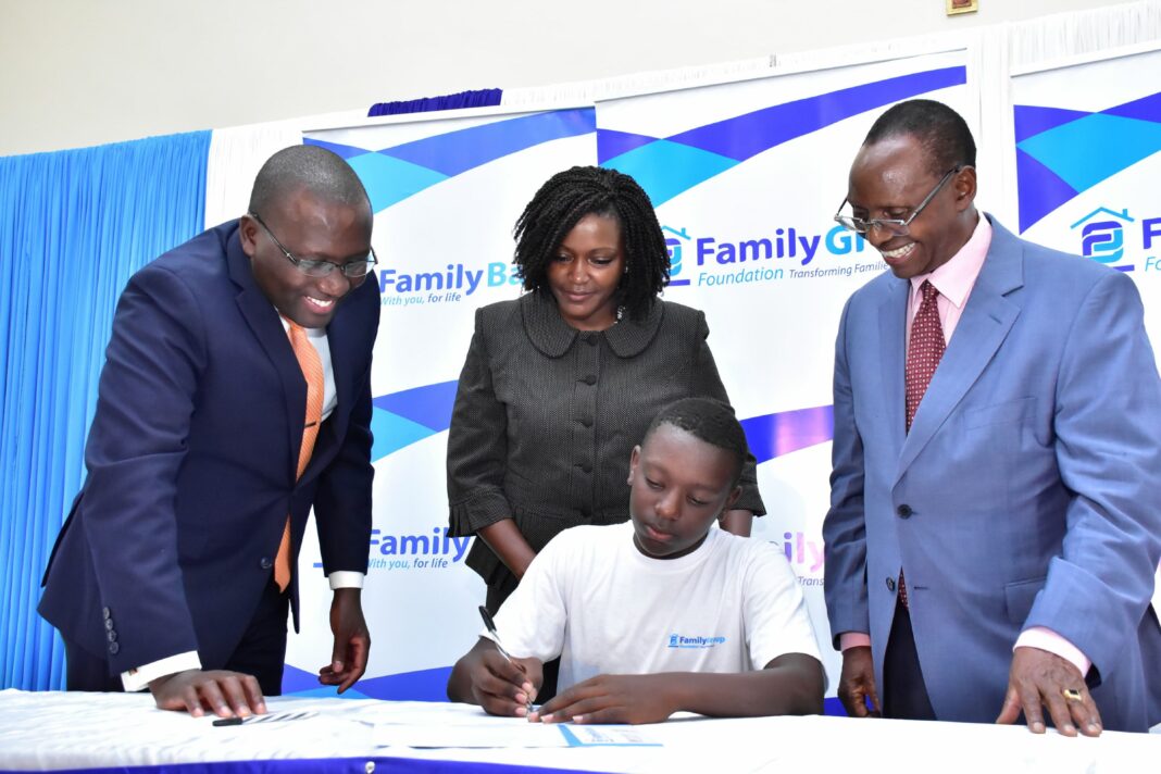 The Family Group Foundation Chairman Dr. Francis Muraya,Family Bank CEO Rebecca Mbithi, the Bank's Chairman Dr. Wilfred Kiboro with Antony Opondo one of the 2022 highschool scholarship beneficiary during last year's commissioning ceremony - Bizna Kenya (Publisher)