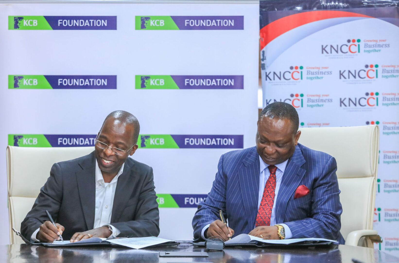 (L to R) Chief Commercial Officer, KCB Group, Sam Makome and KNCCI President Richard Ngatia sign an MOU toward supporting MSMEs and corporations in the country to access financial and non-financial services through the KCB Bank and KCB Foundation - Bizna Kenya (Publisher)