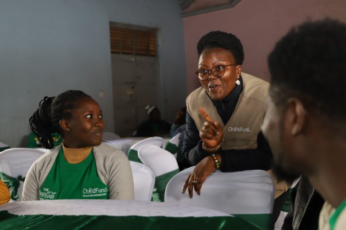 ChildFund Kenya Country Director Alice Anukur chats with youthful participants during the launch of the Tunawiri Na Taka waste management programme in Mukuru slum in Nairobi - Bizna Kenya (Publisher)