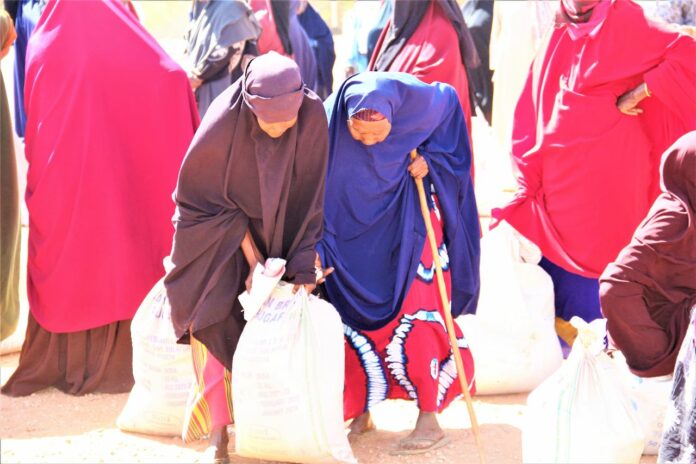 Hundreds of residents of Mandera County receive relief food donated by KCB Foundation. The KShs. 1 million worth of foodstuff will be distributed County Government, KCB Branch Staff and National Drought Management Authority (NDMA) agents; with vulnerable groups such as women, widows, orphans, the elderly, and persons with disabilities being prioritized - Bizna Kenya (Publisher)