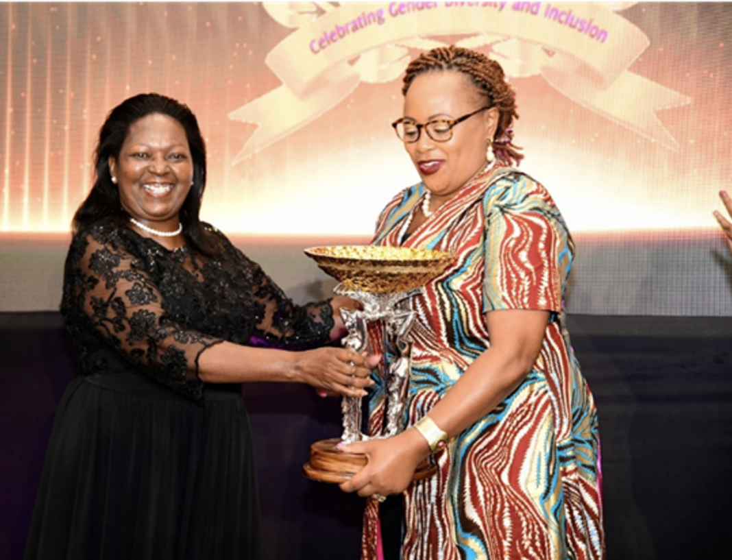 Equity Group Executive Director Mary Wamae (L) presents a trophy to the winner of the 2022 Overall Women On Boards Award, CEO of Space & Style Winnie Ngumi (R). Mary was the inaugural winner during the 2021 Women on Boards Award - Bizna Kenya (Publisher)