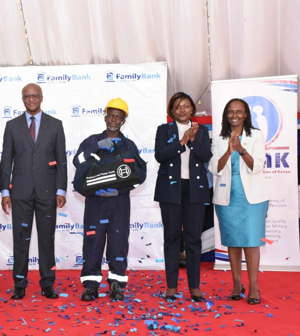 Joseph Okembe, the top performer of the technical and vocational training program by The Family Group Foundation and Military Wives Association of Kenya (MWAK), joins Chief of Kenya Defence Forces Gen. Francis Ogolla, Family Bank CEO Rebecca Mbithi & MWAK Chair Aileen Ogolla (R) during the graduation of 51 dependents of KDF service men & women - Bizna Kenya I Picture courtesy.