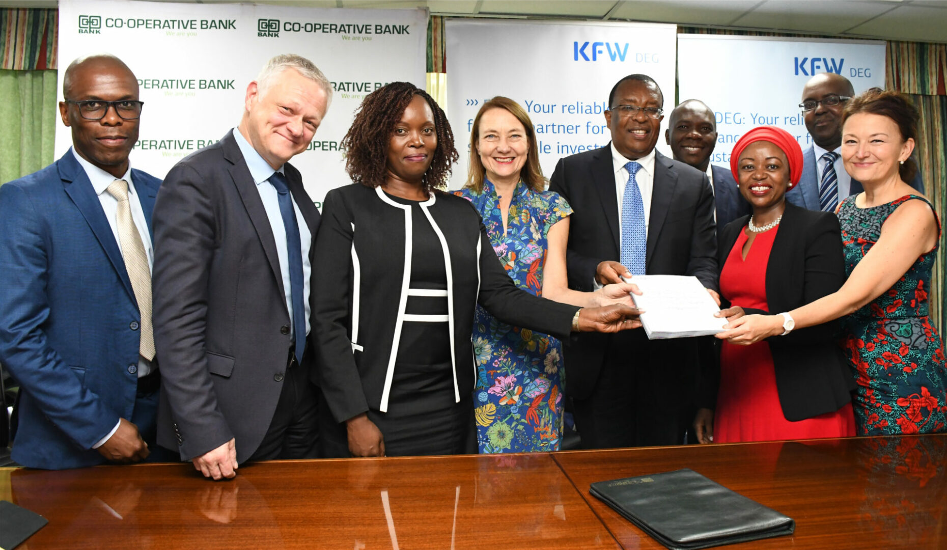 DONE DEAL: The DEG-led Consortium and Co-op Bank teams after sign-off of the $100 Million financing agreement. (L-R) Wilfred Apunda - Senior Investment Manager DEG, Michael Fischer - Director Financial Institutions Africa at DEG, Caroline Karimi – Director Finance & Strategy Co-op Bank, Monika Beck - Member of DEG’s Management Board, Dr Gideon Muriuki - Group Managing Director & CEO Co-op Bank, Judy Kinyanjui – Investment Director Norfund and Antje Steiner – Regional Director East Africa at KfW DEG. Partly hidden at the back are William Nyaoke – Regional Director East Africa, Norfund and Sam Kibugi - Company Secretary Co-op Bank - Bizna Kenya