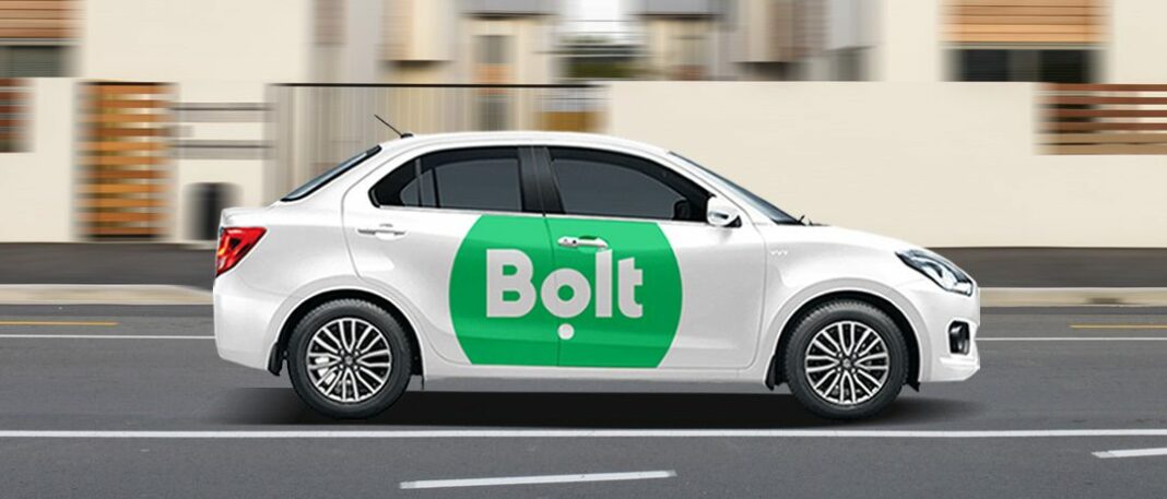 An image of a taxi branded with the Bolt logo