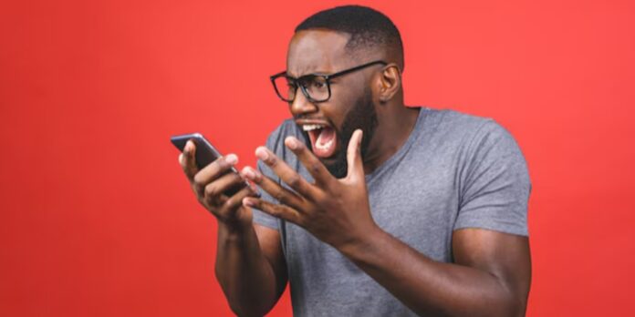 A black man yelling at his phone